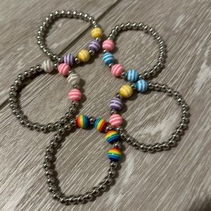 Silver small child stretch bracelet with multiple colors in 4 striped beads.